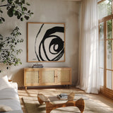 Black and White Abstract III by Anne Tavoletti. Shown in a natural wood frame in a cozy modern living room. Available as an archival giclee rolled canvas, fine art paper, or poster print. SKU 77914a.