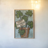 Clover Pot by Anne Tavoletti. shown as a paper print in a natural frame. Available as a archival giclee rolled canvas, fine art paper, or poster print. SKU 56644h.