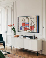 Coastal Buoys I by Anne Tavoletti. shown as a framed stretched canvas in a living room above a console. Available as a archival giclee rolled canvas, fine art paper, or poster print. SKU 43273i.