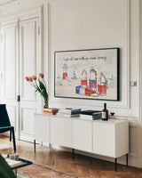 Coastal Buoys II by Anne Tavoletti. shown as a framed stretched canvas in a living room above a console. Available as a archival giclee rolled canvas, fine art paper, or poster print. SKU 44750i.