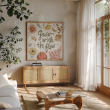 Full Bloom VI by Anne Tavoletti. Shown in a natural wood frame in a cozy modern living room. Available as an archival giclee rolled canvas, fine art paper, or poster print. SKU 90011a.