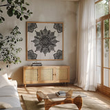 Mandala Morning VI BW by Anne Tavoletti. Shown in a natural wood frame in a cozy modern living room. Available as an archival giclee rolled canvas, fine art paper, or poster print. SKU 46610a.