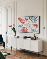 Seafood Shanty I by Anne Tavoletti. shown as a framed stretched canvas in a living room above a console. Available as a archival giclee rolled canvas, fine art paper, or poster print. SKU 40389i.