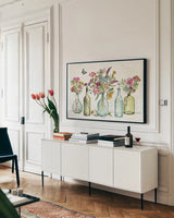 Simply Petals I by Anne Tavoletti. shown as a framed stretched canvas in a living room above a console. Available as a archival giclee rolled canvas, fine art paper, or poster print. SKU 38885i.