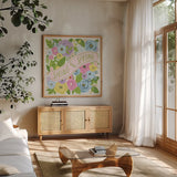 Spring Has Sprung I Bright by Anne Tavoletti. Shown in a natural wood frame in a cozy modern living room. Available as an archival giclee rolled canvas, fine art paper, or poster print. SKU 71347a.