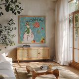 Sweet Snowmen I Blue by Anne Tavoletti. Shown in a natural wood frame in a cozy modern living room. Available as an archival giclee rolled canvas, fine art paper, or poster print. SKU 20570a.