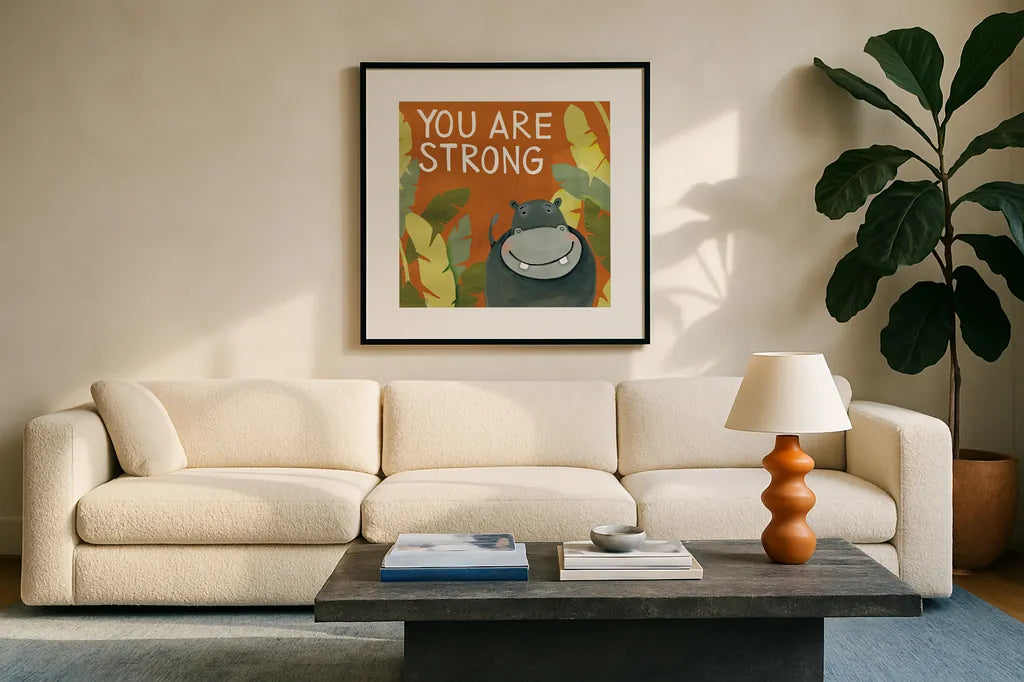You Are Strong by Anne Tavoletti. Displayed in a glass frame with matte in a clean modern living room. Available as an archival giclee rolled canvas, fine art paper, or poster print. SKU 18513a.