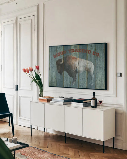 Bison Trading Co by Avery Tillmon. shown as a framed stretched canvas in a living room above a console. Available as a archival giclee rolled canvas, fine art paper, or poster print. SKU 57492i.