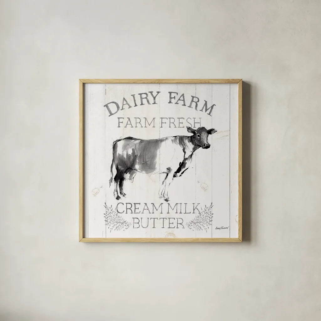 Dairy Farm Wood Black Cow Sq by Avery Tillmon. Shown in a natural wood glass frame for a timeless modern aesthetic. Available as an archival giclee rolled canvas, fine art paper, or poster print. SKU 81173a.