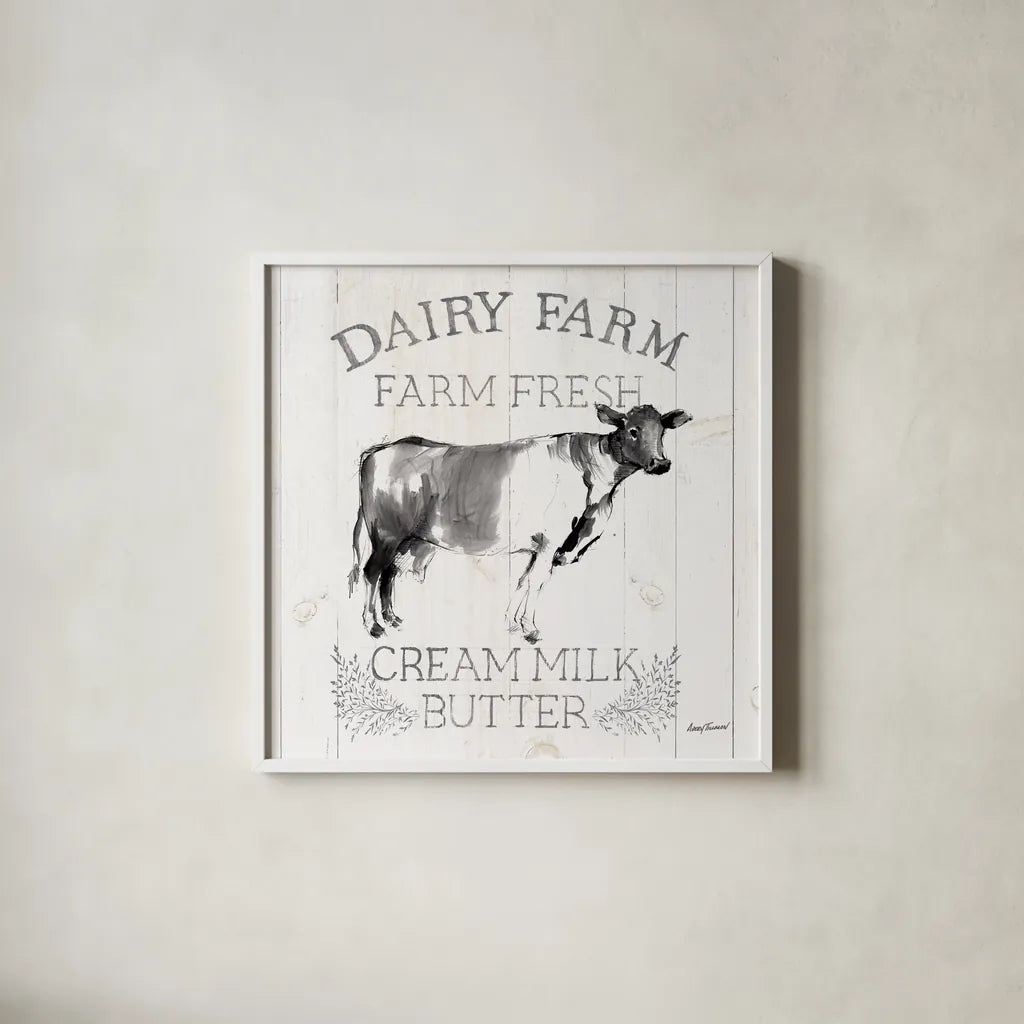 Dairy Farm Wood Black Cow Sq by Avery Tillmon. Shown in a crisp white glass frame for a clean and minimalist style. Available as an archival giclee rolled canvas, fine art paper, or poster print. SKU 81173a.