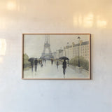 Eiffel in the Rain by Avery Tillmon. shown as a paper print in a natural frame. Available as a archival giclee rolled canvas, fine art paper, or poster print. SKU 16714i.