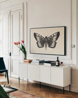 Moth V by Avery Tillmon. shown as a framed stretched canvas in a living room above a console. Available as a archival giclee rolled canvas, fine art paper, or poster print. SKU 76818i.