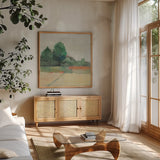 Path Through the Field Green by Avery Tillmon. Shown in a natural wood frame in a cozy modern living room. Available as an archival giclee rolled canvas, fine art paper, or poster print. SKU 26514a.