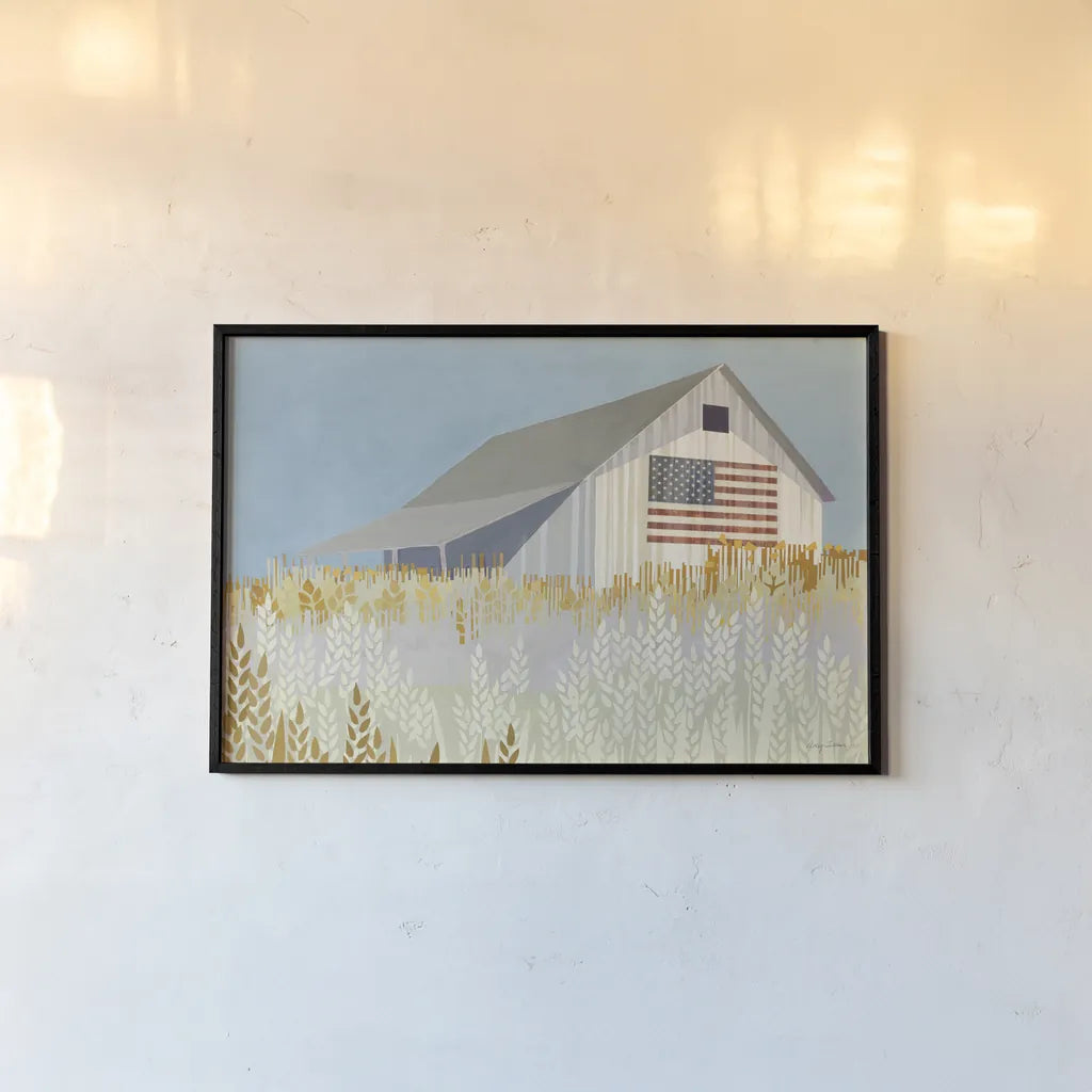 Wheat Fields Barn with Flag by Avery Tillmon. shown as a paper print in a black flame. Available as a archival giclee rolled canvas, fine art paper, or poster print. SKU 76408i.