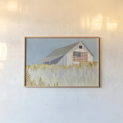 Wheat Fields Barn with Flag by Avery Tillmon. shown as a paper print in a natural frame. Available as a archival giclee rolled canvas, fine art paper, or poster print. SKU 76408i.