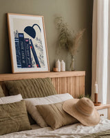 Bookish Blue I by Becky Thorns. shown as a paper print in a natural frame. Available as a archival giclee rolled canvas, fine art paper, or poster print. SKU 97119h.