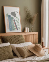 Bookish Blue I v2 by Becky Thorns. shown as a paper print in a natural frame. Available as a archival giclee rolled canvas, fine art paper, or poster print. SKU 101554h.