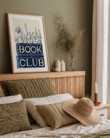 Bookish Blue II by Becky Thorns. shown as a paper print in a natural frame. Available as a archival giclee rolled canvas, fine art paper, or poster print. SKU 97120h.