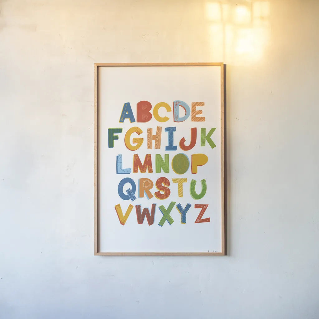 Colorful Alphabet by Becky Thorns. shown as a paper print in a natural frame. Available as a archival giclee rolled canvas, fine art paper, or poster print. SKU 59586h.