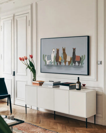 Delightful Alpacas V by Becky Thorns. shown as a framed stretched canvas in a living room above a console. Available as a archival giclee rolled canvas, fine art paper, or poster print. SKU 53091i.