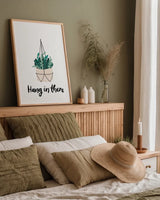 Hang in There by Becky Thorns. shown as a paper print in a natural frame. Available as a archival giclee rolled canvas, fine art paper, or poster print. SKU 65069h.