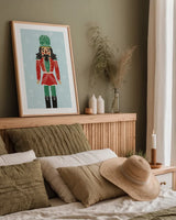 Holiday Cheer Nutcrackers I by Becky Thorns. shown as a paper print in a natural frame. Available as a archival giclee rolled canvas, fine art paper, or poster print. SKU 83912h.