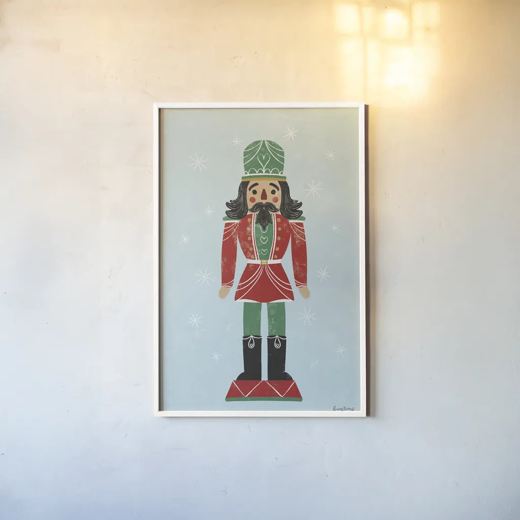 Holiday Cheer Nutcrackers I by Becky Thorns. shown as a paper print in a white frame. Available as a archival giclee rolled canvas, fine art paper, or poster print. SKU 83912h.