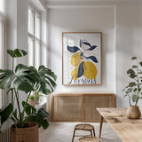 Lemons I by Becky Thorns. shown as a print in a natural wood frame in a dining room. Available as a archival giclee rolled canvas, fine art paper, or poster print. SKU 64702h.