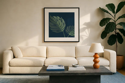 Monstera II by Becky Thorns. Displayed in a glass frame with matte in a clean modern living room. Available as an archival giclee rolled canvas, fine art paper, or poster print. SKU 52080a.