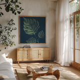 Monstera IV by Becky Thorns. Shown in a natural wood frame in a cozy modern living room. Available as an archival giclee rolled canvas, fine art paper, or poster print. SKU 52082a.