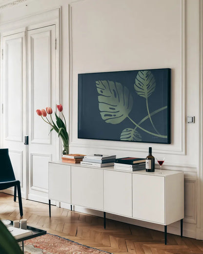 Monstera V by Becky Thorns. shown as a framed stretched canvas in a living room above a console. Available as a archival giclee rolled canvas, fine art paper, or poster print. SKU 52083i.