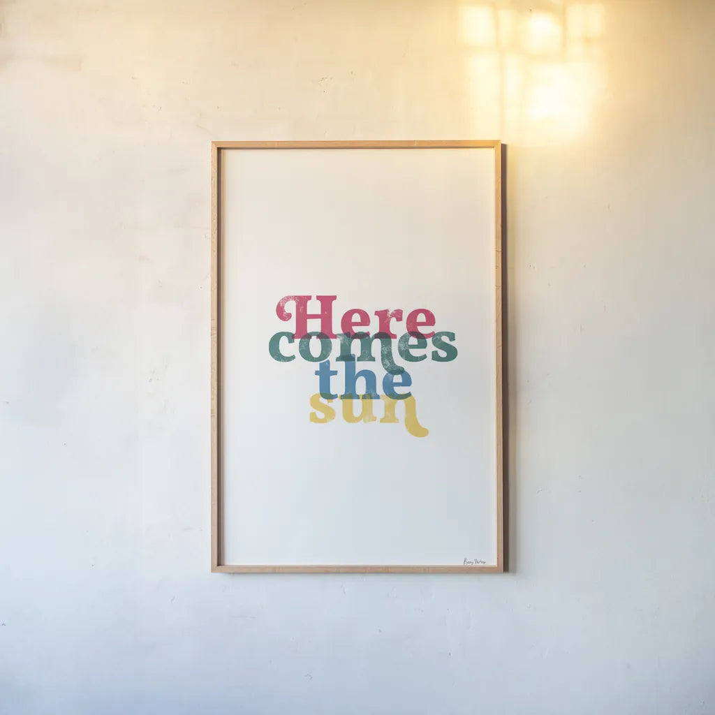 Rainbow Here Comes the Sun by Becky Thorns. shown as a paper print in a natural frame. Available as a archival giclee rolled canvas, fine art paper, or poster print. SKU 65202h.