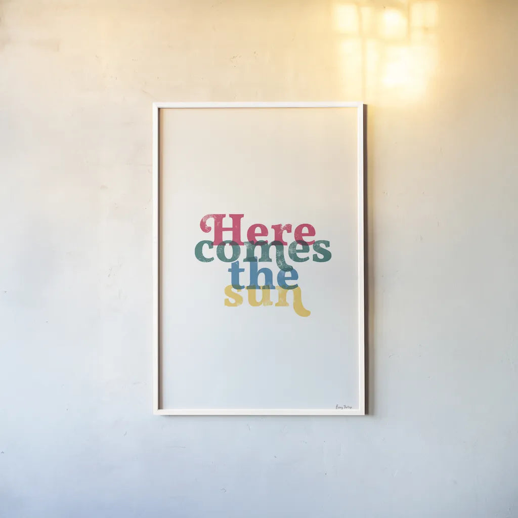 Rainbow Here Comes the Sun by Becky Thorns. shown as a paper print in a white frame. Available as a archival giclee rolled canvas, fine art paper, or poster print. SKU 65202h.