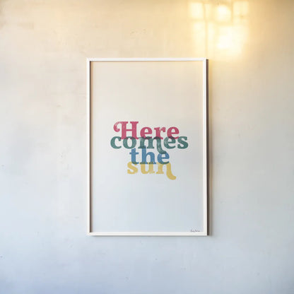 Rainbow Here Comes the Sun by Becky Thorns. shown as a paper print in a white frame. Available as a archival giclee rolled canvas, fine art paper, or poster print. SKU 65202h.