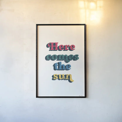 Rainbow Here Comes the Sun Bold by Becky Thorns. shown as a paper print in a black flame. Available as a archival giclee rolled canvas, fine art paper, or poster print. SKU 65214h.