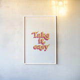 Rainbow Take it Easy Bold by Becky Thorns. shown as a paper print in a white frame. Available as a archival giclee rolled canvas, fine art paper, or poster print. SKU 65220h.