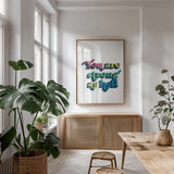 Rainbow You Are Strong Bold by Becky Thorns. shown as a print in a natural wood frame in a dining room. Available as a archival giclee rolled canvas, fine art paper, or poster print. SKU 65215h.