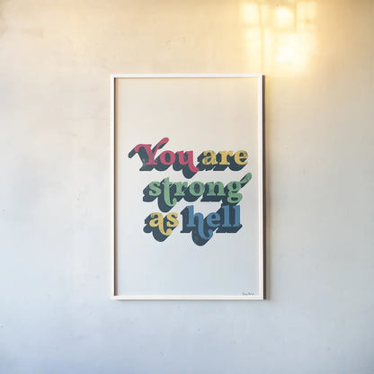 Rainbow You Are Strong Bold by Becky Thorns. shown as a paper print in a white frame. Available as a archival giclee rolled canvas, fine art paper, or poster print. SKU 65215h.