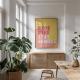 Work Hard Stay Humble by Becky Thorns. shown as a print in a natural wood frame in a dining room. Available as a archival giclee rolled canvas, fine art paper, or poster print. SKU 56778h.