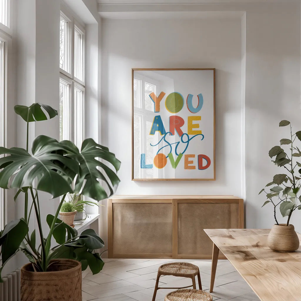 You Are So Loved by Becky Thorns. shown as a print in a natural wood frame in a dining room. Available as a archival giclee rolled canvas, fine art paper, or poster print. SKU 59585h.