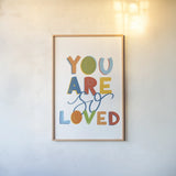You Are So Loved by Becky Thorns. shown as a paper print in a natural frame. Available as a archival giclee rolled canvas, fine art paper, or poster print. SKU 59585h.