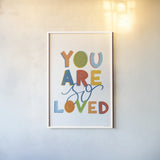 You Are So Loved by Becky Thorns. shown as a paper print in a white frame. Available as a archival giclee rolled canvas, fine art paper, or poster print. SKU 59585h.
