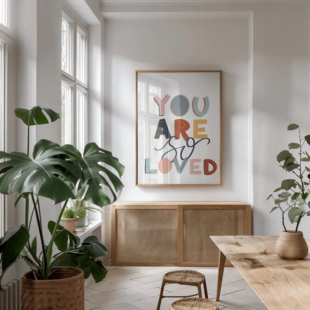 You Are So Loved Pastel by Becky Thorns. shown as a print in a natural wood frame in a dining room. Available as a archival giclee rolled canvas, fine art paper, or poster print. SKU 66562h.