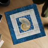 Sea Shell on Blue II by Belinda Aldrich. Shown as a detailed flat fine art print, highlighting archival giclee quality. Available as an archival giclee rolled canvas, fine art paper, or poster print. SKU 11934a.