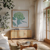 Blue Hydrangea I LIght by Beth Grove. Shown in a natural wood frame in a cozy modern living room. Available as an archival giclee rolled canvas, fine art paper, or poster print. SKU 21474a.