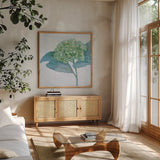 Blue Hydrangea II Light by Beth Grove. Shown in a natural wood frame in a cozy modern living room. Available as an archival giclee rolled canvas, fine art paper, or poster print. SKU 21475a.