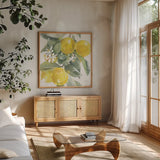 Citrus Charm Lemons I by Beth Grove. Shown in a natural wood frame in a cozy modern living room. Available as an archival giclee rolled canvas, fine art paper, or poster print. SKU 66092a.