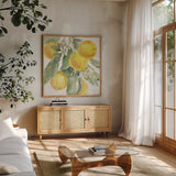 Citrus Charm Lemons II by Beth Grove. Shown in a natural wood frame in a cozy modern living room. Available as an archival giclee rolled canvas, fine art paper, or poster print. SKU 66093a.