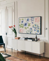 Indigo Petals I by Beth Grove. shown as a framed stretched canvas in a living room above a console. Available as a archival giclee rolled canvas, fine art paper, or poster print. SKU 78053i.