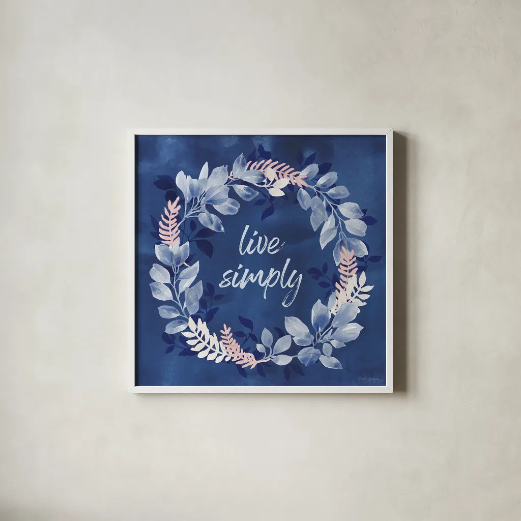 Indigo Petals IV by Beth Grove. Shown in a crisp white glass frame for a clean and minimalist style. Available as an archival giclee rolled canvas, fine art paper, or poster print. SKU 78056a.